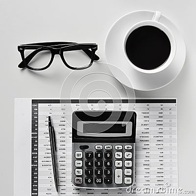 Eyeglasses, coffee and calculator on an office desk Stock Photo
