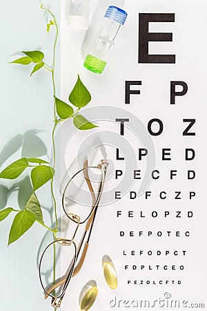 Eyeglasses, contact lenses, vitamins and Snellen table Stock Photo