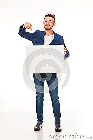 A guy with a beard posing with a white sign. Can be used for advertising, logo and business cards, contact phones, shares, etc. Stock Photo