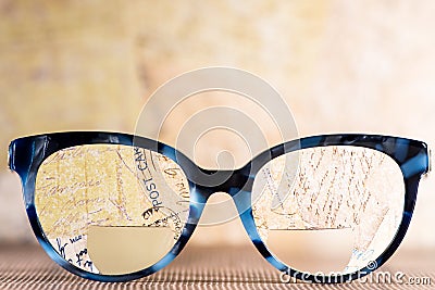 Eyeglasses Glasses with Bifocals and Black blue Frame smudged agaist written letters. Blurry Vision Concept Stock Photo