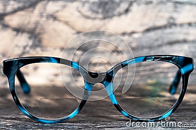 Eyeglasses Glasses with Bifocals and Black Blue Frame smudged Fashion Vintage Style on Wood Desk Background, Rustic Still Life Stock Photo