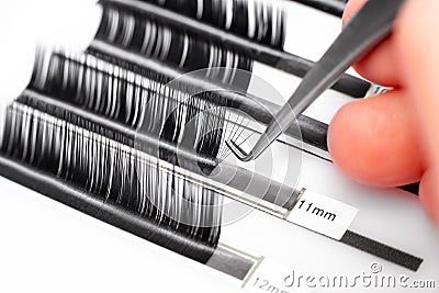 Eyelash extension procedure. Lashes tweezers set macro photo, white background Stock Photo
