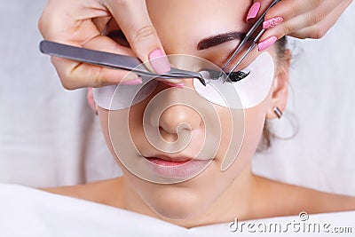 Eyelash Extension Procedure. Woman Eye with Long Eyelashes. Lashes, close up, macro, selective focus. Stock Photo