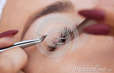 Eyelash removal procedure close up. Beautiful Woman with long lashes in a beauty salon Stock Photo