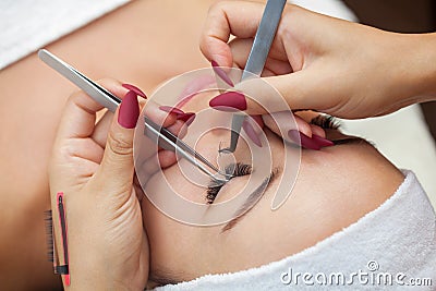 Eyelash removal procedure close up. Beautiful Woman with long lashes in a beauty salon. Stock Photo