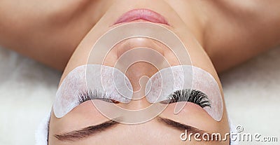 Eyelash removal procedure close up. Beautiful Woman with long lashes in a beauty salon. Stock Photo