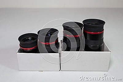 Eyepieces for a telescope in a box on a white background close-up Stock Photo
