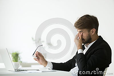 Eyes fatigue at work, tired exhausted businessman taking off gla Stock Photo