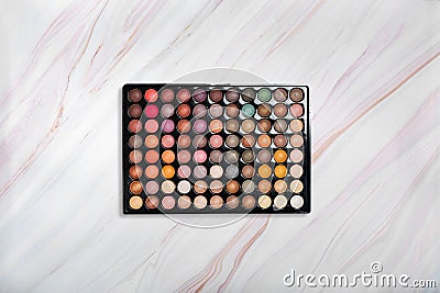 Eyeshadow palette on marble texture with natural pattern. Flat lay. Top view Stock Photo