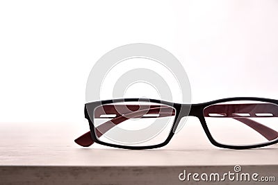 Eyewear on wood table and white background front view detail Stock Photo