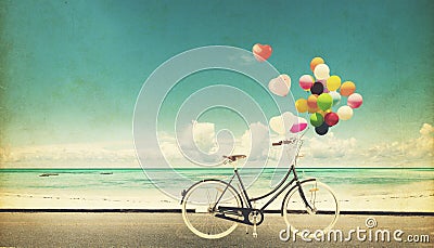 F bicycle vintage with heart balloon on beach blue sky Stock Photo