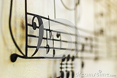 F Clef Bass Clef old steel on the old wall with music note blu Stock Photo