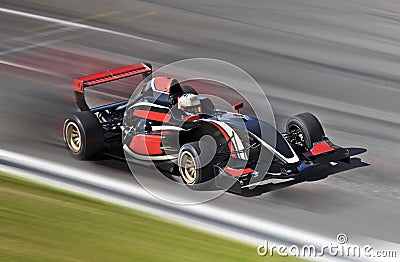 F1 race car racing on a track with motion blur Stock Photo