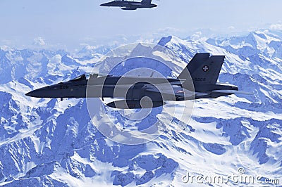 FA-18 military jets from Swiss Airforce escorting civil airplaine in the swiss alps Editorial Stock Photo