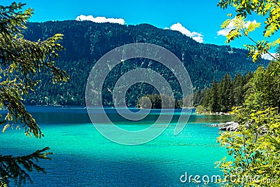 Faboulus landscape of Eibsee Lake with turquoise water in front of Zugspitze summit under sunlight. Location: Eibsee lake, Stock Photo