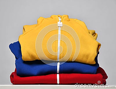 Fabric children sportswear stack, bodysuit store assortment Stock Photo