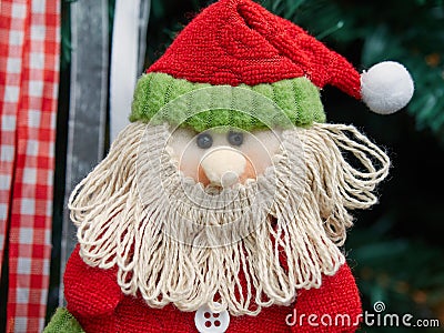 Fabric decorative santa claus hung up on Christmas tree Stock Photo