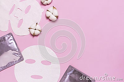 Fabric face mask, cotton flowers on pink background. Concept of natural cosmetics, face care, spa, face cream, women`s beauty Stock Photo