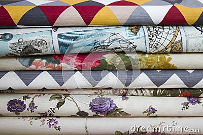 Fabricate silk and cloth on the shop shelf, rolled silk in the market, multicolor and many pattern texture background Stock Photo