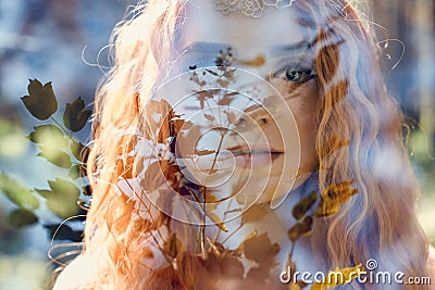 Fabulous portrait of a red-haired girl in nature with double exposure and glare. Beautiful redhead girl with long hair in forest Stock Photo