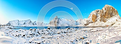 Fabulous shore of Reinefjorden on Toppoya island with Olstinden and Festhaeltinden peaks on background Stock Photo