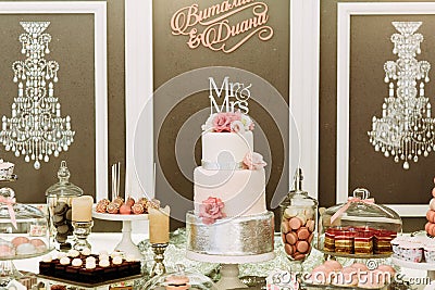 Fabulous wedding cake with the macaroons and cupcakes Stock Photo
