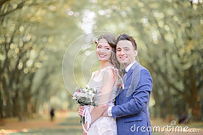 Fabulous wedding couple stands in green and yellow autumn park Stock Photo