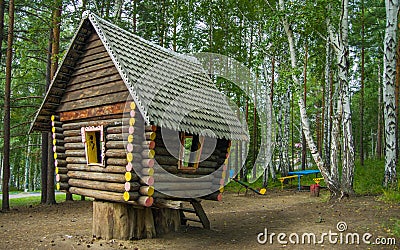 Fabulous wooden hut stands on stumps in the forest Stock Photo