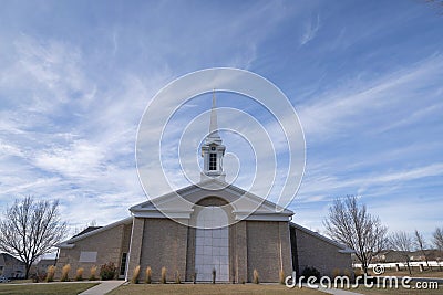 Facade of a church in a low angle view with a sky and clouds background Stock Photo