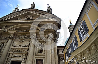 Facade of the church of St. Catherine in Graz and the upper part of an elegant building. Stock Photo