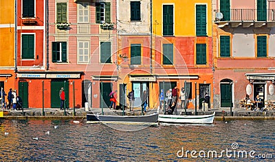15.03.2018. facade of colorful old buildings and architecture with people walking on dock in small coastal village Portofino in Li Editorial Stock Photo