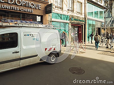 Facade of Credit Agricole bank and Cottel Reseau fiber optic integrator van Editorial Stock Photo