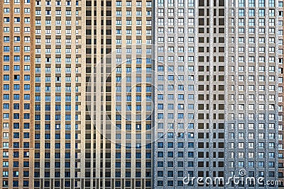 Facade of a huge multi-storey residential complex. Lots of identical windows. Texture or background Stock Photo