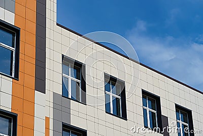 Facade of a modern building on a bright Sunny day, siding and Windows, beautiful exterior of the new building Stock Photo