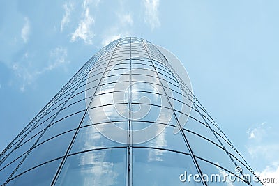 Facade of modern skyscraper with reflection of cloudy sky, low angle shot,copy space Stock Photo