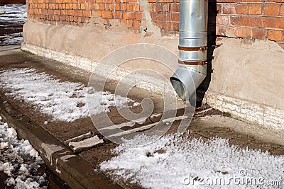 A close-up on a metal rain gutter downpipe Stock Photo