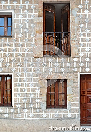 Facade of old building with decorative patterns and wooden doors Stock Photo