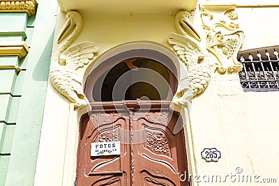 Facade of an old building with a sign: Photos of Havana in the old historical center in Havana, Cuba, Caribbean Editorial Stock Photo