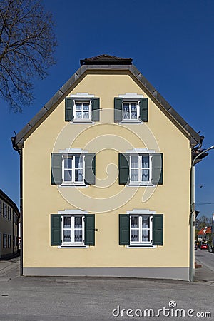 Facade of an old generic house with wooden window shutter Stock Photo