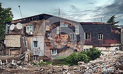 Facade of old residential half demolished building Stock Photo