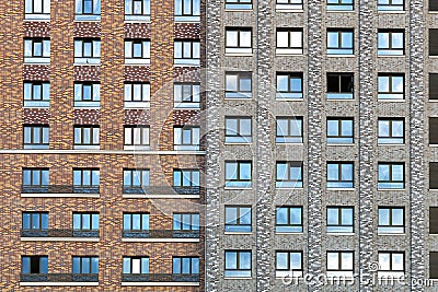 The facade of a residential high-rise building in brown and gray tones. Rows of windows. Urban residential skyscraper Stock Photo