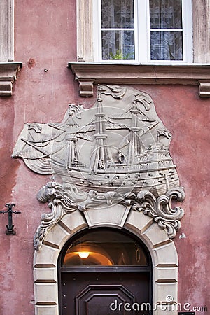 Facade with a sailing boat on St. John Street Ulica Swietojanska, located in the old town of Warsaw, Masovian, Poland, Europe Editorial Stock Photo