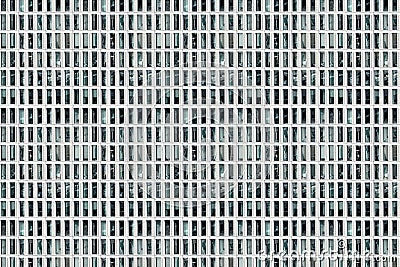 Facade of skyscraper with elongated rectangular windows, abstract colorless image, composite, concept for monotony Stock Photo