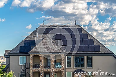 Facade of a solar powered home with spiral staircase going up to the balcony Stock Photo