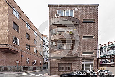 Facade of a three-story residential building with brown brick seen Stock Photo