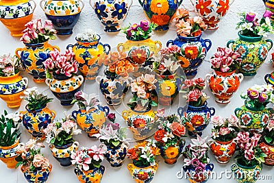 Decorative ceramic plates and pots of colorful flowers in the historic Albaicin neighbourhood. Stock Photo