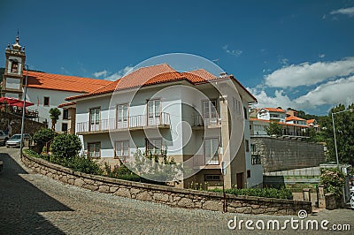 Facade of two-story house with stone wall Editorial Stock Photo