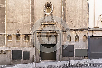 Facade of a very old building with granite ashlars, windows with old wrought iron railings and renovated stone floors Stock Photo