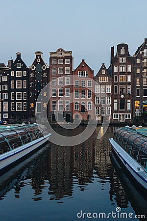 facades of ancient building above canal on twilight, Amsterdam, Netherlands Editorial Stock Photo