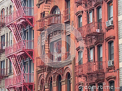 Facades of historic buildings in the Soho district of New York. The characteristic iron safety stairs on the facades Stock Photo
